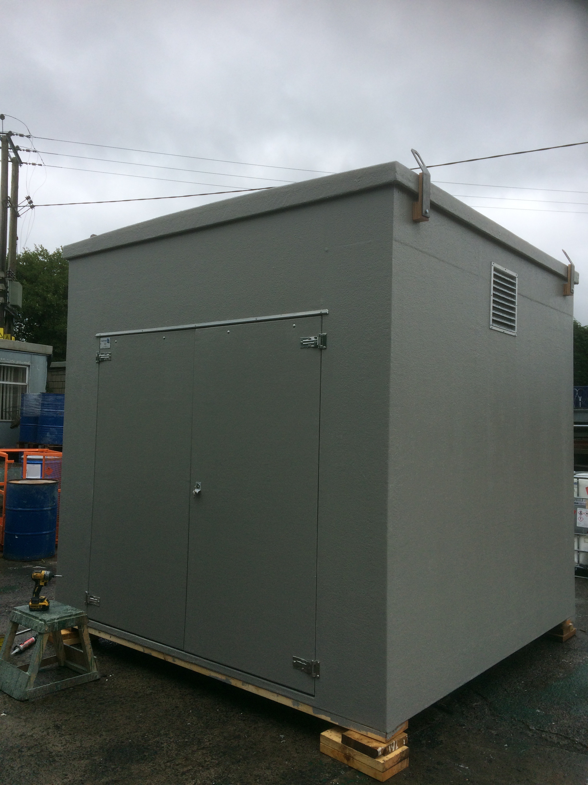 Tall grey GRP enclosure kiosk with service doors