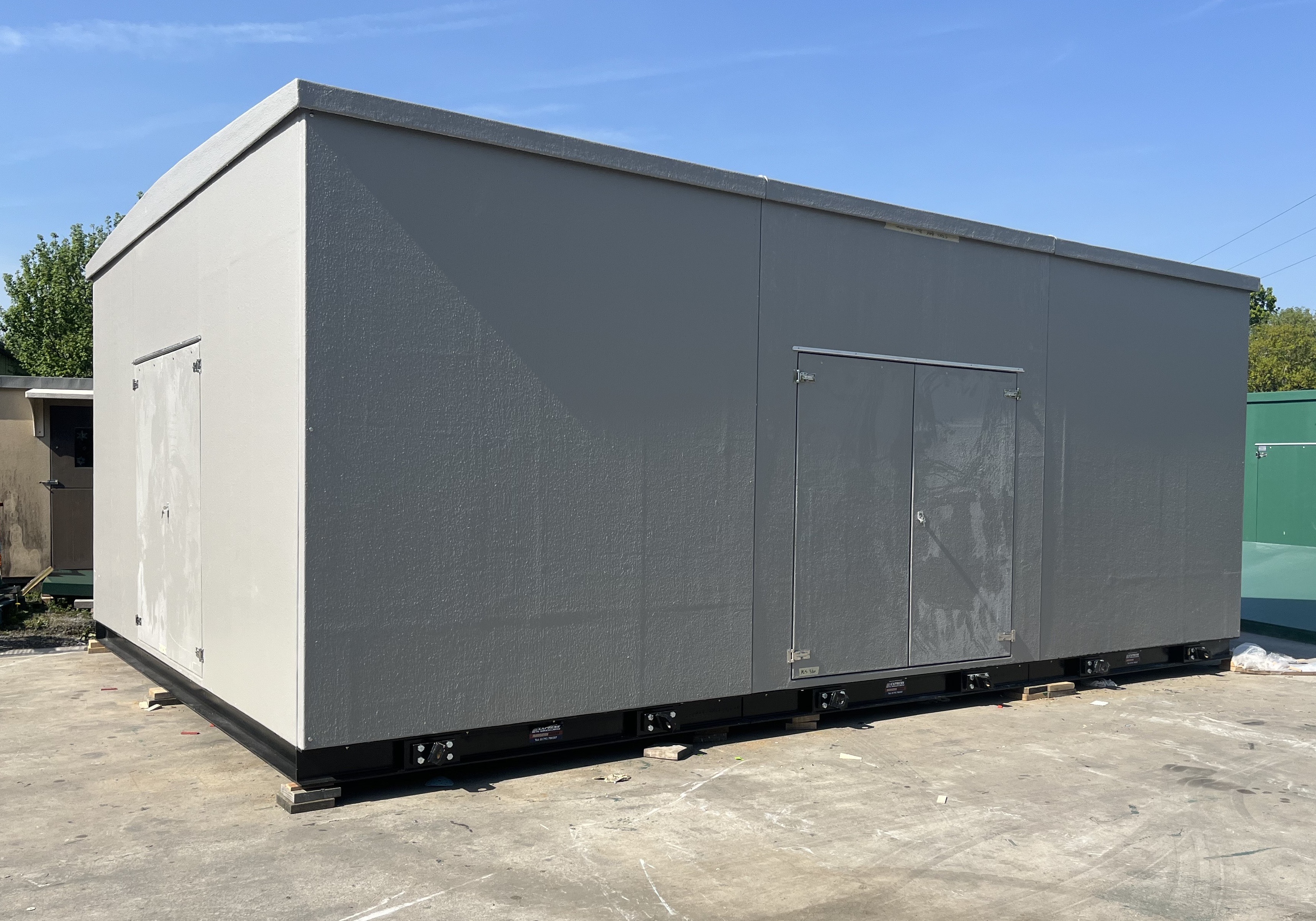 Large grey GRP enclosure with double access doors