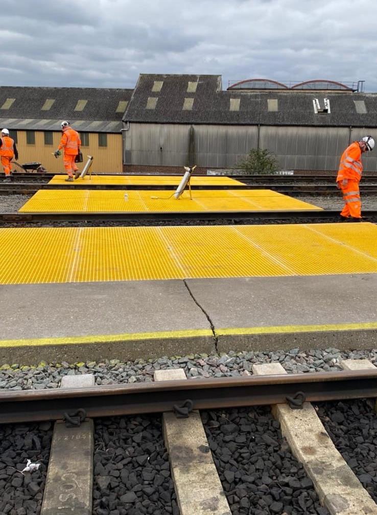 Yellow GRP grating installed at a rail site