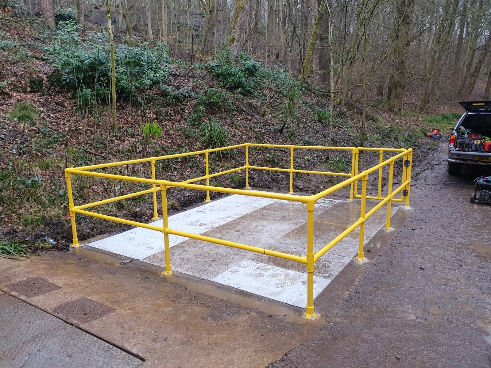 Yellow GRP handrail surrounding an access platform