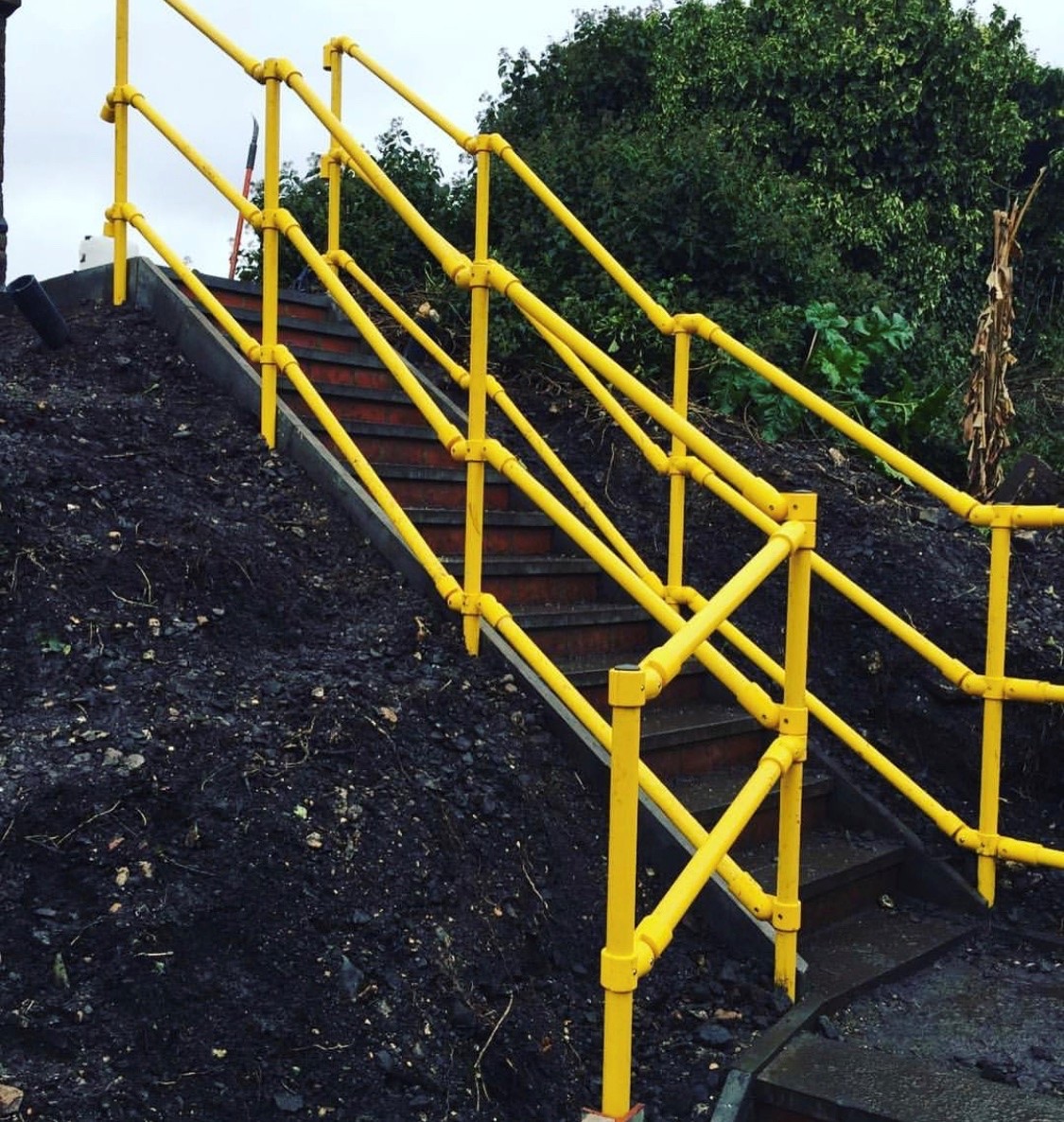 Yellow GRP handrails on external stairs