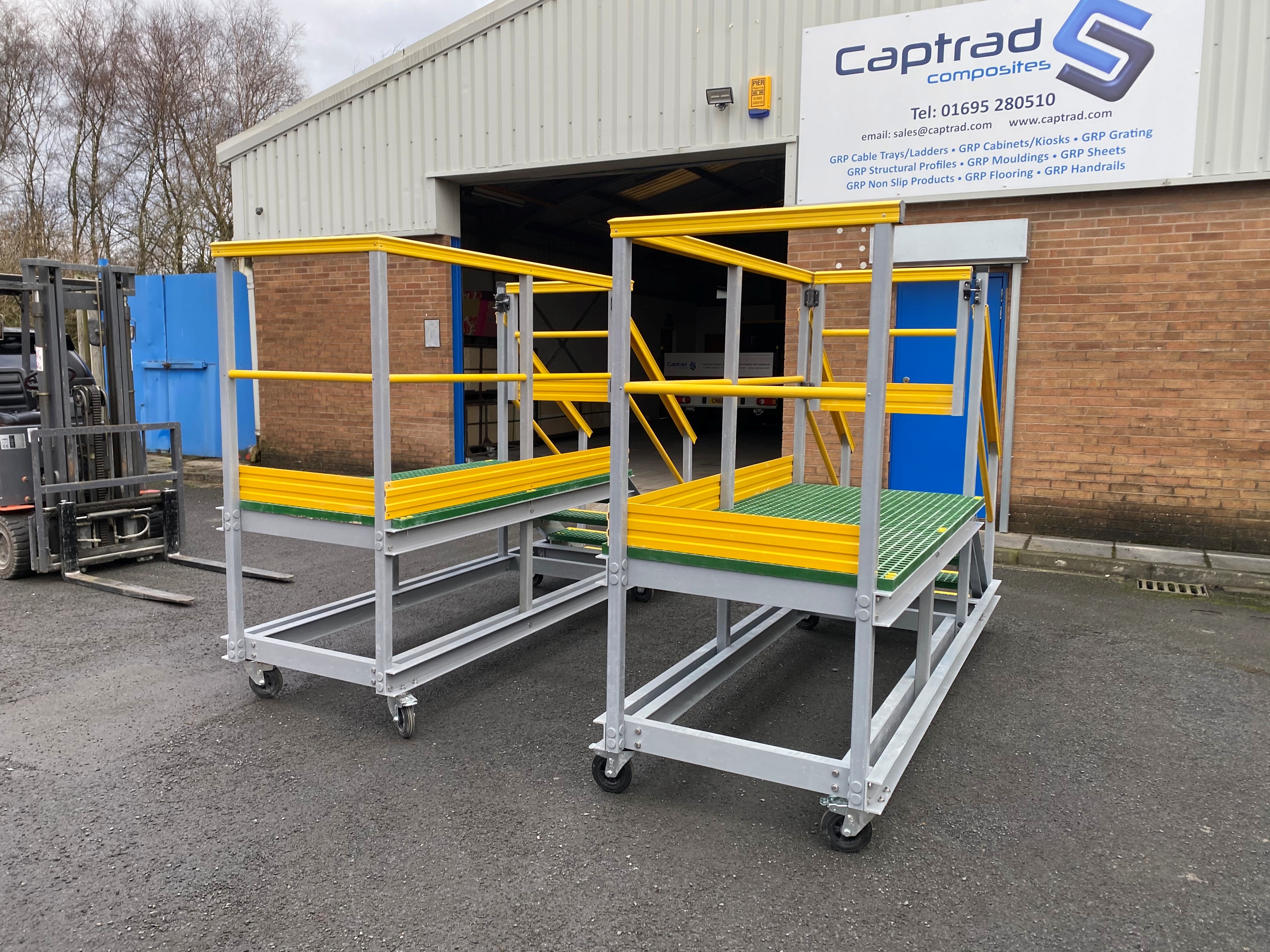 Mobile GRP access platform with yellow handrails